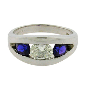 Oval diamond with round sapphires set in 14 k white gold