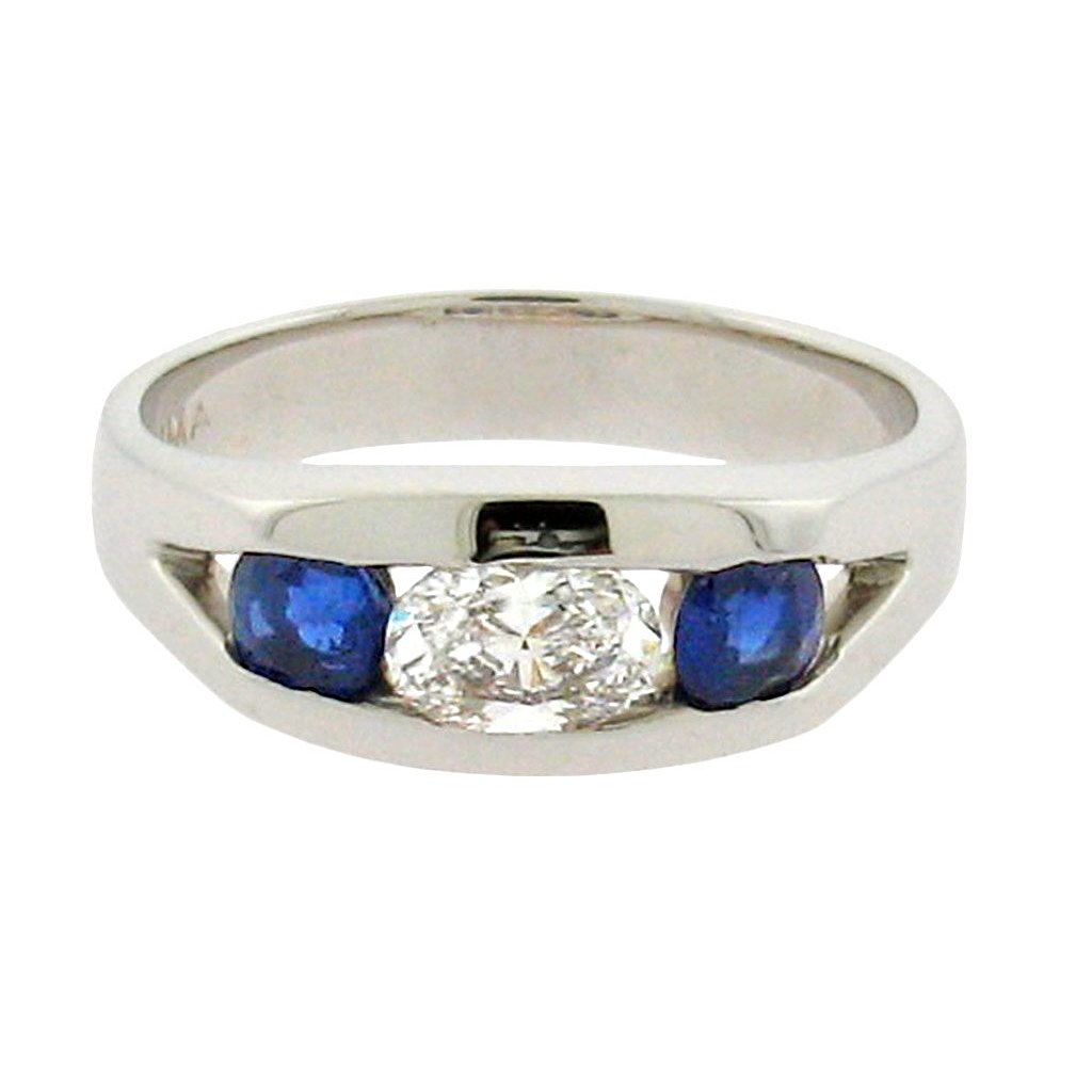 Oval diamond with round sapphires set in 14 k white gold