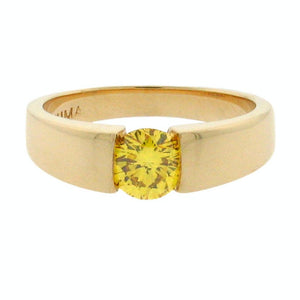 round fancy yellow diamond set in a 14 k yellow gold ring