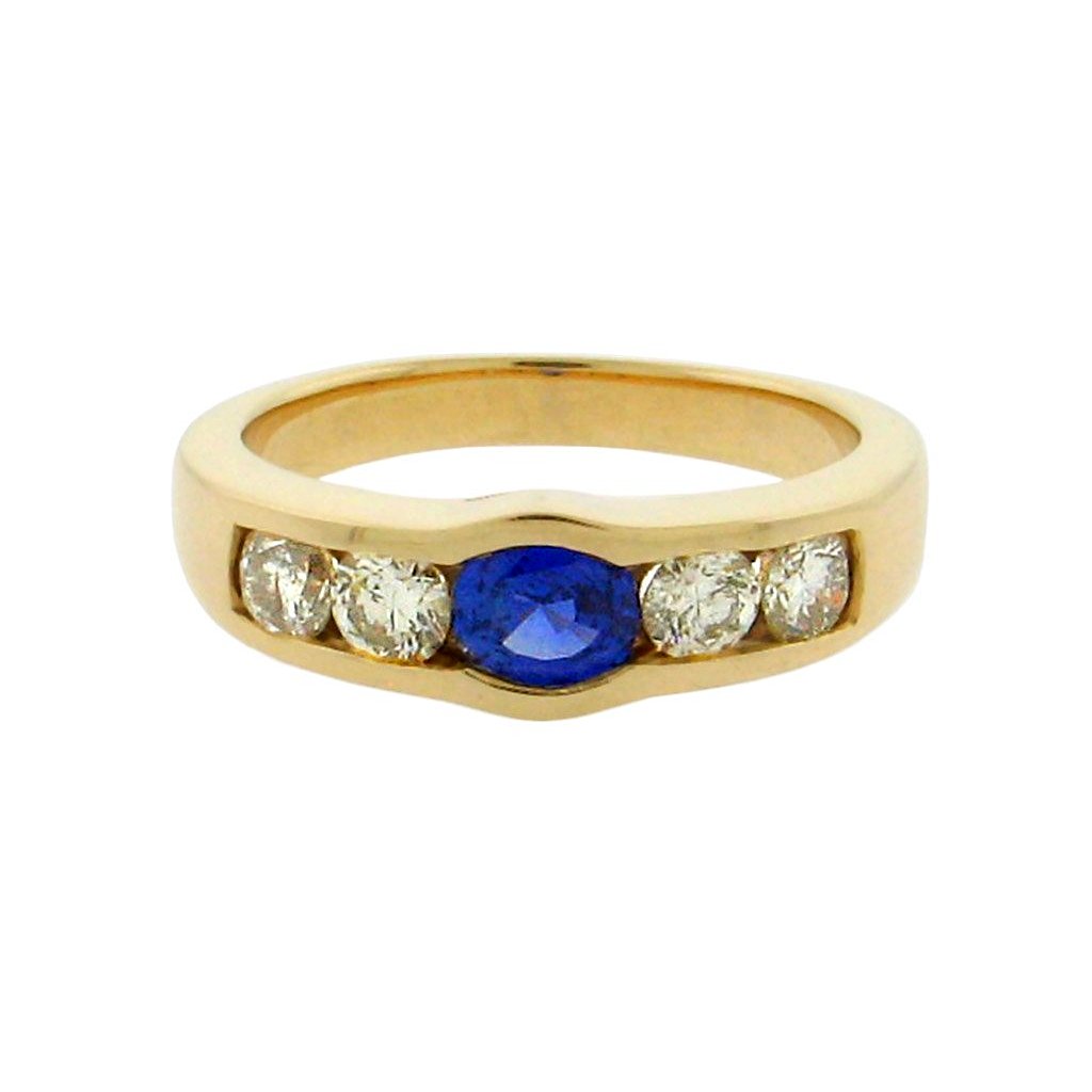.95 ct oval sapphire  1.2 ct total weight round diamonds  14 k yellow gold ring